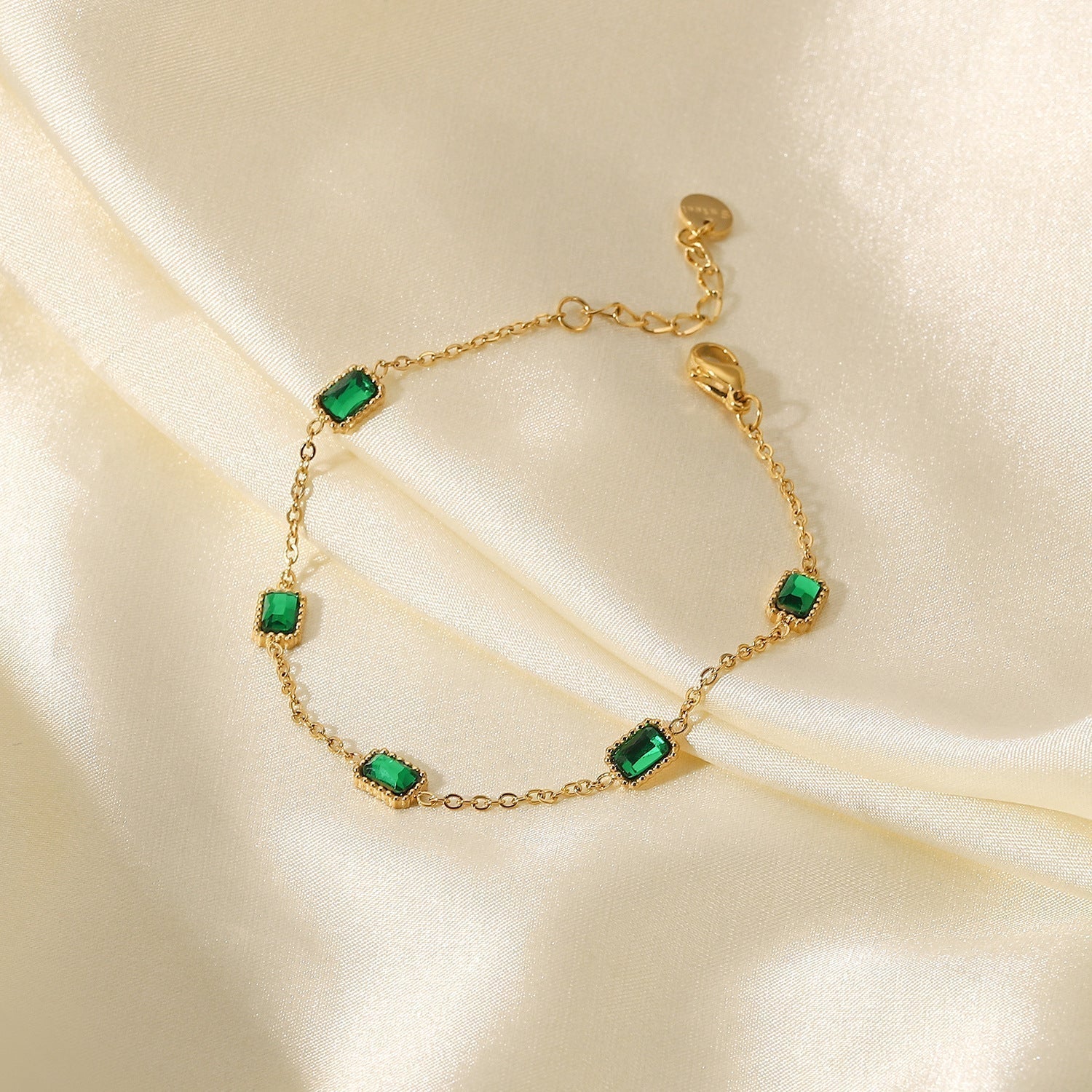 Women’s Elegant Gold Bracelet with Green Gemstones